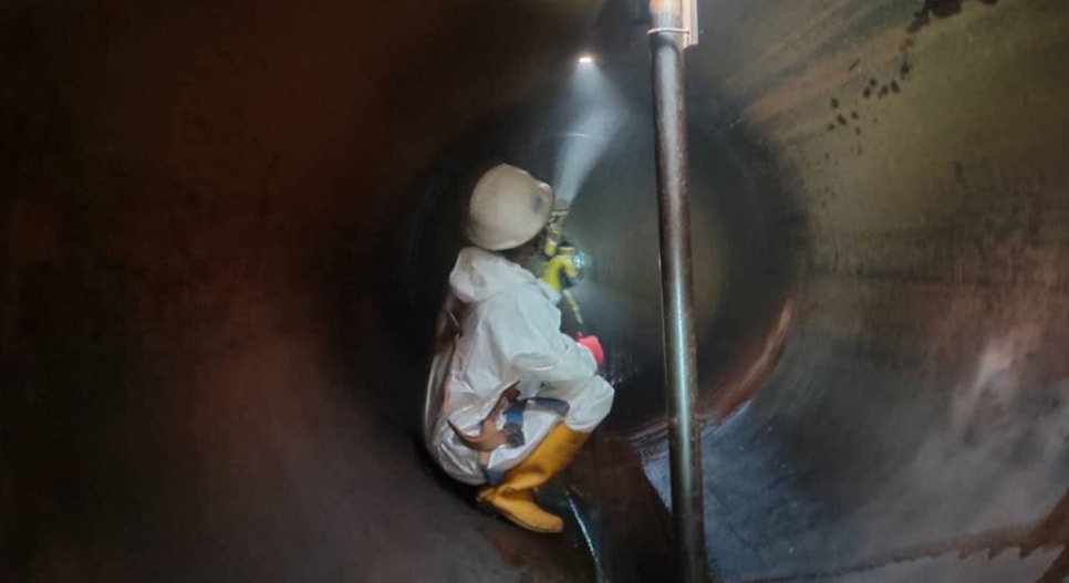 Specialist performing an industrial tank cleaning operation